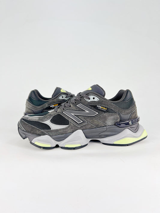 New Balance 9060 sneakers shown are in a black and cement colorway, often featuring a durable mesh and suede construction with Lime accents