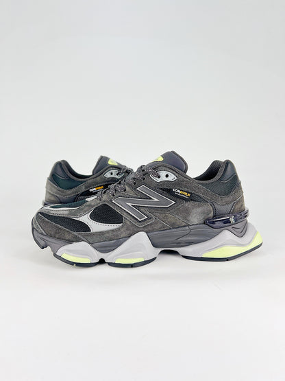 New Balance 9060 sneakers shown are in a black and cement colorway, often featuring a durable mesh and suede construction with Lime accents